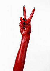 Red Devil's hands, red hands of Satan, white background isolated