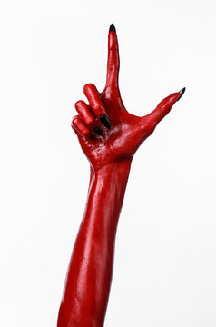 Red Devil's hands, red hands of Satan, white background isolated