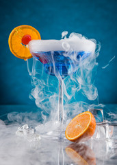Cocktail with ice vapor on bar desk