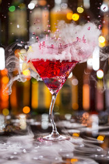 Cocktail with ice vapor on bar desk