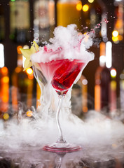 Cocktail with ice vapor on bar desk
