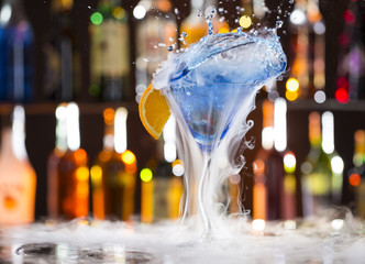 Cocktail with ice vapor on bar desk