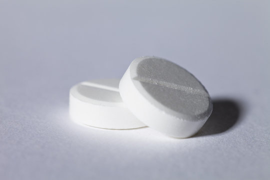 Close-up of Two White pills on a table
