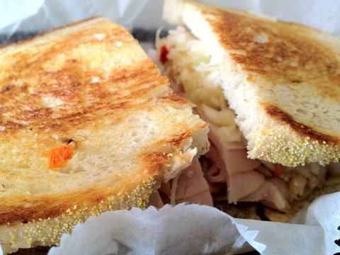 Close-up of a toasted California Ruben sandwichon white sourdough bread