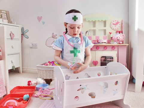 Girl (4-5) Playing Dress Up As Nurse