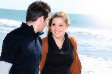 Young couple in love walking along the seashore