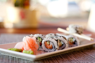 Japanese seafood sushi, roll and chopstick on white plate
