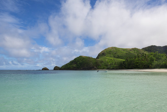 Boat anchored on a tropical beach in Pacific Ocean, Fiji