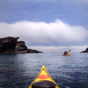 Spain, Costa Brava, Kayaking among cliffs