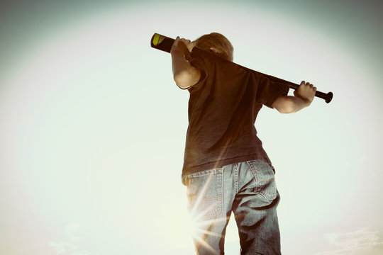 USA, Colorado, Young boy (6-7) with baseball bat over shoulders