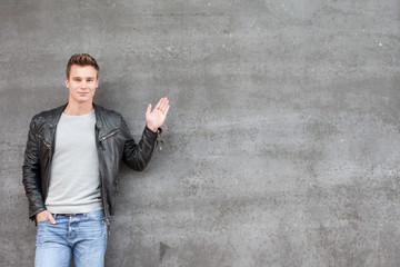 Casual young guy pointing to the side