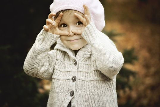 Child framing face with hands