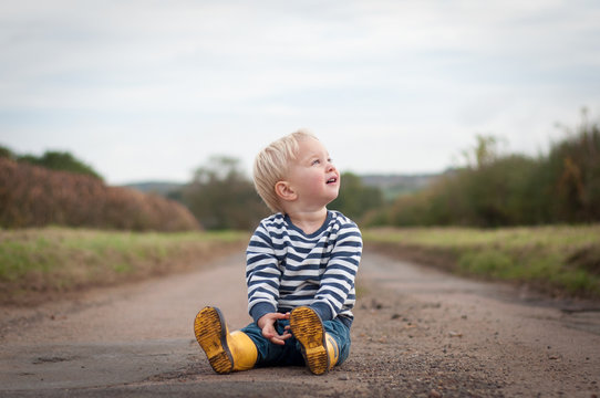 Boy sitting on path