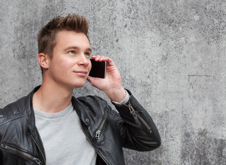 Casual young guy using smart phone