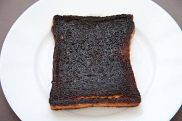 Close-up of a slice of burnt toast on a plate