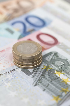 Close-up of a Stack of Euro coins on assorted euro banknotes