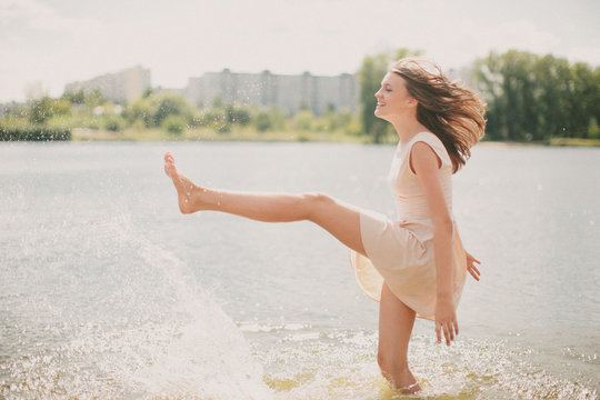 Teenage girl (14-15) playing with water