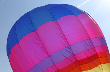 hot air balloon flies in sky blue