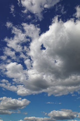 Blue sky with white cumulus clouds.