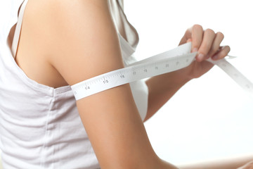 Young woman on diet measuring her fat, Beauty body care and diet