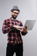 Charismatic guy with ntebooki in glasses and plaid shirt 