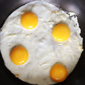 London, UK, Four Eggs Frying In A Pan
