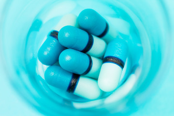 Close up of blue pills in a jar
