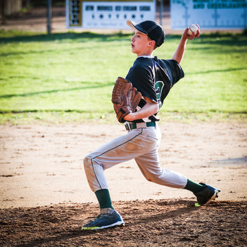 USA, Young boy (10-11) pitching on pitchers mound