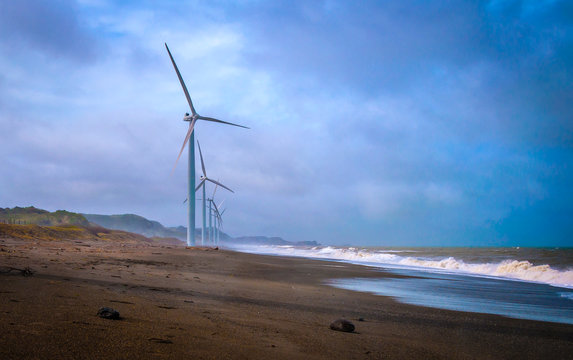 Side view of a Row of wind turbines on a sandy beach, Laoag, Ilocos Norte, Philippines