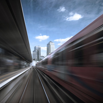 View of a train station from speeding train Canary Wharf, London, England, UK