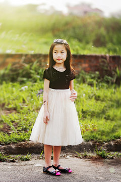 Girl (6-7) standing on path 