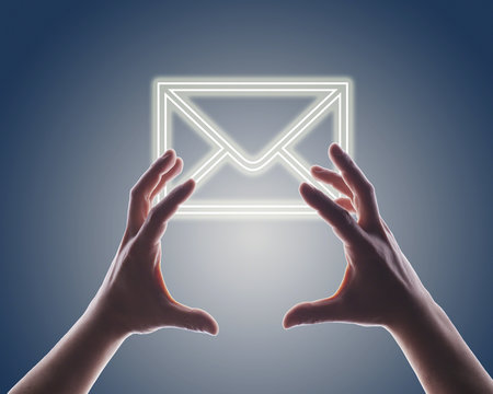 Woman's hands reaching digitally generated image of envelope