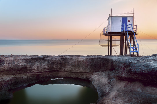 Traditional raditional French carrelet fishing cabin on wooden stilts built along the rugged rocky cliffs of Puits de l'Auture, Saint-Palais-sur-Mer, Charente-Maritime, France