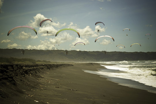 Indonesia, Yogyakarta Region, Jogja, Paragliding above Parang Tritis Beach