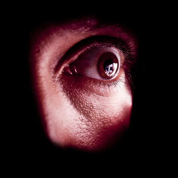 Close-up of eye with reflection of word sex