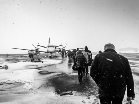 Sweden, Kalmar, Kalmar Airport, Passengers boarding small airplane in winter
