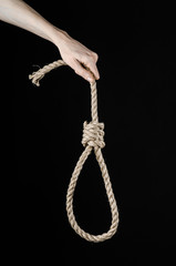 man's hand holding a loop of rope for hanging on  isolated