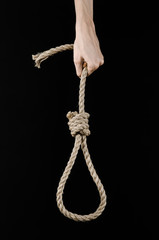man's hand holding a loop of rope for hanging on  isolated