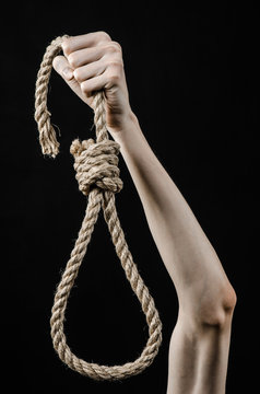 man's hand holding a loop of rope for hanging on  isolated