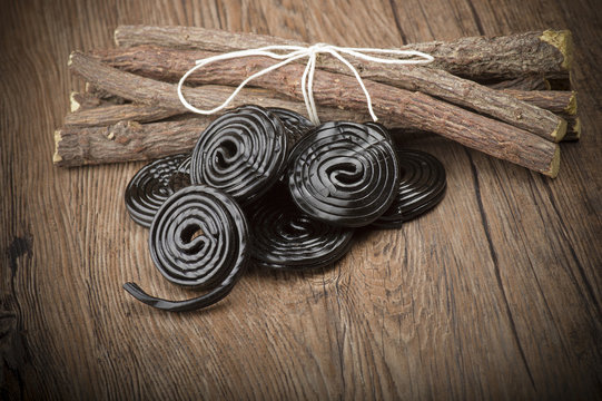 Licorice wheels candies close up on the wood