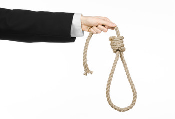 Hand of a businessman holding a loop of rope for hanging