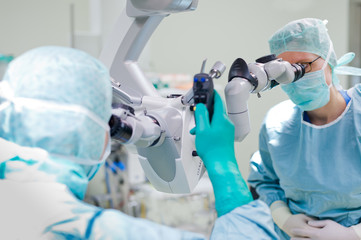 Doctors looking through eye test equipment