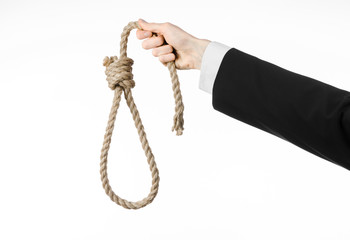 Hand of a businessman holding a loop of rope for hanging