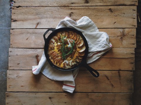Fritatta in cooking pan on table