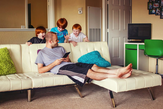 Three young boys (2-3, 4-5, 6-7) trying to surprise their father