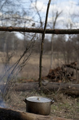 Cooking in old sooty cauldron on campfire