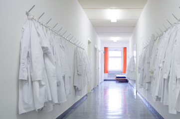 Germany, Lab coats hanging in corridor in laboratory