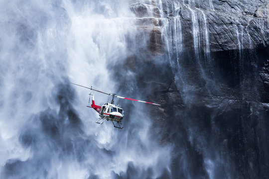 Helicopter flying past Yosemite Falls, Yosemite National Park, California, USA
