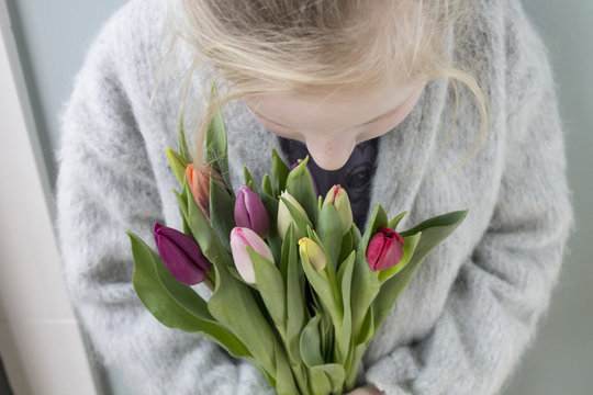 Girl holding a bunch of tulips