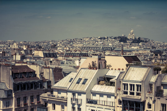 Paris with its old buildings, rooftops and Montmartre in the background